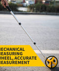 Measuring Wheel For Meters With Carrying Bag Telescopic Design And Reset Button Plus Starting Point Arrow in use on pavement.
