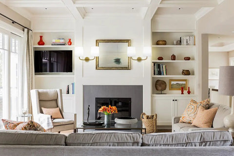 Living room with Industrial Battery Powered Wall Sconce With Two Light LED Fixture, white fabric shade, above fireplace.