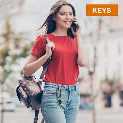 Woman using phone with keys attached to Beefy 12kN Heavy Duty Carabiner Clips With Ultralight Screw Lock Locking Design for Keychains