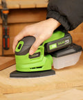 Person using Garage Shop Ready Compact Detail Sander With 1.1A Motor Delivers 14,000 OPM For Smooth Woodworking on wood surface