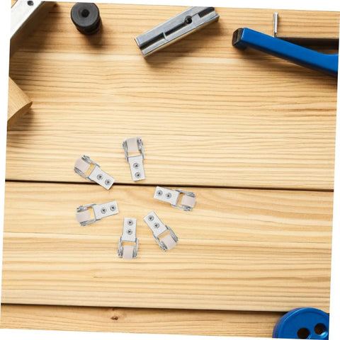 Heavy Duty Nylon Sliding Door Rollers With Smooth As Butter Ride For Cabinets And Drawer Units Features Six One Inch White Pulleys arranged on wooden surface.