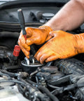 Orange Nitrile Work Gloves Diamond Grip Eight Mil Thick Case Of Nine Hundred Extra Large Powder Free Latex Free Build Forged Solid For Mechanics Keeping Grease Off Their Hands While Crushing The Daily Grind On Automotive Jobs, worn by mechanic working on car engine.