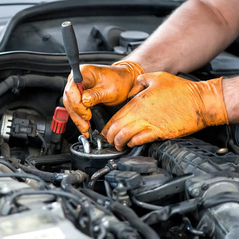 Orange Nitrile Work Gloves Diamond Grip Eight Mil Thick Case Of Nine Hundred Extra Large Powder Free Latex Free Build Forged Solid For Mechanics Keeping Grease Off Their Hands While Crushing The Daily Grind On Automotive Jobs, worn by mechanic working on car engine.