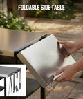 Stainless Steel Grill Cart And Pizza Oven Table With Wheels For Infrared Grills Universal Outdoor BBQ Station Built To Last Fits Ooni Ninja Gozney And More Sturdy Prep Surface With Ample Storage Shelf And Mobility with a foldable side table