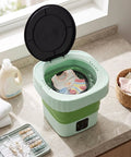 Laundry Day No Sweat With This 6L Folding Portable Washing Machine filled with children's clothes on a kitchen countertop.