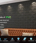Decorative 3D Wall Panels Black PVC 12x12 Inch Tiles covering a living room wall with ambient lighting and a brown couch.