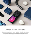 Assorted smart water network components including wireless sensor and digital controller displayed on a table.