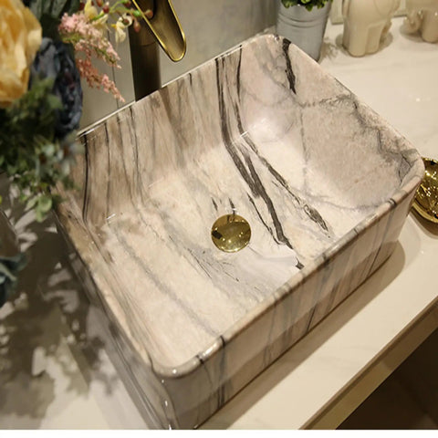 USZWBY Marbling Vessel Sink - Rectangular Ceramic Bathroom Sink with Faucet & Drain Above Counter Vanity Bowl Stylish Art Wash Basin for Modern Bathrooms, close-up view showing marble pattern and drain.