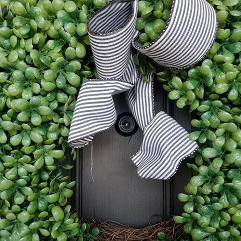 Solid Brass Door Viewer Peephole With 220 Degree View And Privacy Cover on a decorated door with greenery and striped ribbon
