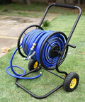 Heavy Duty Garden Hose Reel And Portable Hand Push Hose Cart With Inflatable Wheels, blue hose mounted, on grass.