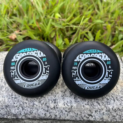 Inline Skate Wheels 4 Pack For Outdoor Indoor Use 78mm 80mm 85A With Bearings Roller Hockey Replacement Wheels on stone ledge