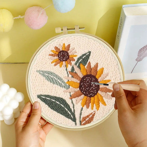 Punch Needle Embroidery Kit Beginner Friendly Two Pack With Tools Embroidery Hoops Two Pre Printed Fabrics And Color Threads Flower Pattern Set Tulip Bouquets And Sunflower Clusters DIY Home Decor Gift Project featuring a completed sunflower embroidery in a hoop.