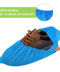 Disposable Shoe Covers For Indoor Use Pack Of 200 With 100 Pairs, Waterproof CPE Booties, shown covering a brown shoe.