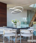 Modern LED Ring Pendant Light Fixture For Dining Rooms And Kitchen Islands, Totally Slick Adjustable Acrylic Grey Chandelier, 36W 4000K Neutral Daylight, Ceiling Mount Not Dimmer Compatible, Great For High Ceilings displayed over a dining table.