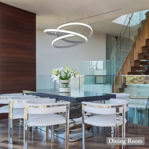 Modern LED Ring Pendant Light Fixture For Dining Rooms And Kitchen Islands, Totally Slick Adjustable Acrylic Grey Chandelier, 36W 4000K Neutral Daylight, Ceiling Mount Not Dimmer Compatible, Great For High Ceilings displayed over a dining table.