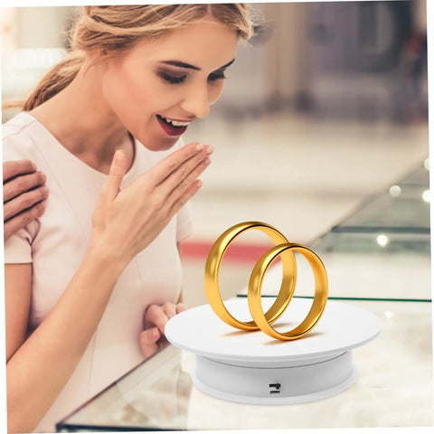 Rorpoir Adjustable Electric Rotating Display Stand For Jewelry And Watches With Anti Skid Base Energy Saving Motorized Turntable showcasing two gold rings.