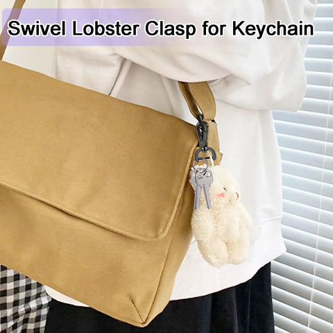 Heavy Duty Detachable Swivel Snap Hooks In Black Set Of Four Lobster Claw Clasps With Tight Grip Action for keychain on tan bag.