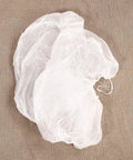 Straight Up Clean And No Drama Disposable Nonwoven Hair Covers With Tension Free Elastic Bands For Salon Beauty Chef Jobs And Long Daily Grind Sessions Pack Of 20 Fresh Caps, two caps showing soft white material on a textured background.