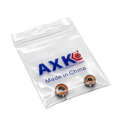 Front view of AXK International 2-piece ceramic bearing set in a clear zip bag; two bearings with orange seals.