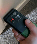 Person using S4-P And Mini-Ligno SD/C Moisture Meter And Mold Detector Kit With E14-M Electrode on wall corner for inspections.
