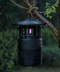 Outdoor Mosquito Trap With Lighting And Sleep Timer That Attracts Mosquitoes Flies Moths Gnats Wasps Beetles And No See Ums Indoor Or Outdoor Bug Zapper With 395nm UV Light For Fast Quiet Hassle Free Catch hanging on a wet tree branch