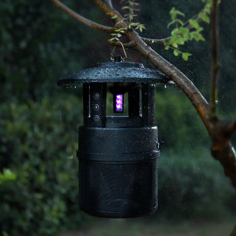 Outdoor Mosquito Trap With Lighting And Sleep Timer That Attracts Mosquitoes Flies Moths Gnats Wasps Beetles And No See Ums Indoor Or Outdoor Bug Zapper With 395nm UV Light For Fast Quiet Hassle Free Catch hanging on a wet tree branch