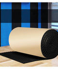 Killer Self Adhesive Egg Crate Acoustic Foam Panels 2 CM Thick Soundproofing Foam rolled on floor against a blue plaid wall.