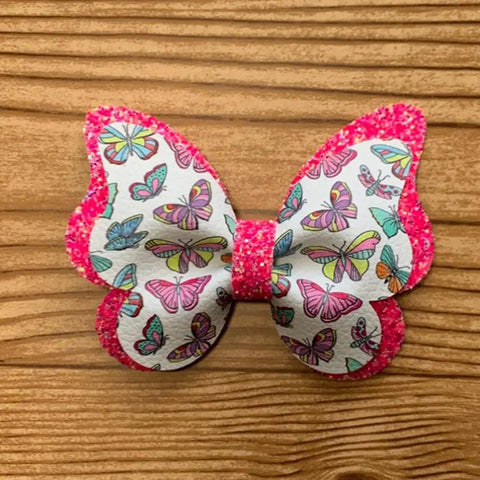 Colorful butterfly bow from 1 Set Butterfly Bow Tie Metal Die Cuts For DIY Scrapbooking And Card Making, on wooden background.