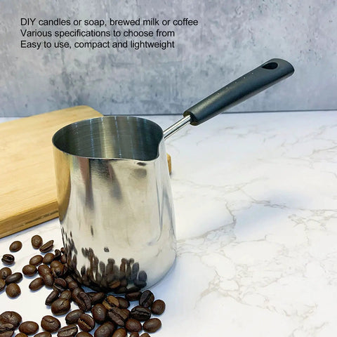 Turkish Coffee Pot And Milk Frothing Jug 21oz 600ml Stainless Steel Toroid Pitcher With Long Handle on a counter with coffee beans.