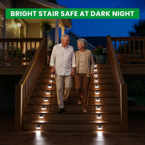 Elderly couple descending stairs with Solar Powered Fence Lights 12 Pack Outdoor Deck Lights Waterproof Stainless Steel Security Wall Lamps illuminating steps at night.