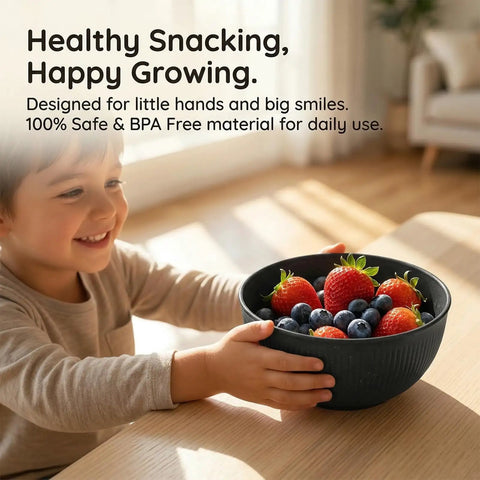 Child holding black bowl filled with strawberries and blueberries from Built Tough 36 Piece Wheat Straw Dinnerware Set For 6 No Fuss Unbreakable Bowls Plates And Cups Dishware Safe For Dishwasher And Microwave Ideal For Outdoor Camping Black.