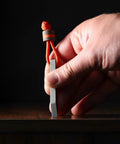 Hand holding Beefy Heavy Duty Keychain Pry Bar For Everyday Carry, Stainless Steel Minimalist EDC Multitool with orange loop.