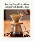 Go To Pour Over Coffee Maker Set With 20oz Borosilicate Glass Carafe Bamboo Base And Spiral Stand V Shaped Dripper 100 Paper Filters Plastic Free Manual Brewer For Home And On The Go Brewing, with coffee being poured into V-shaped dripper.