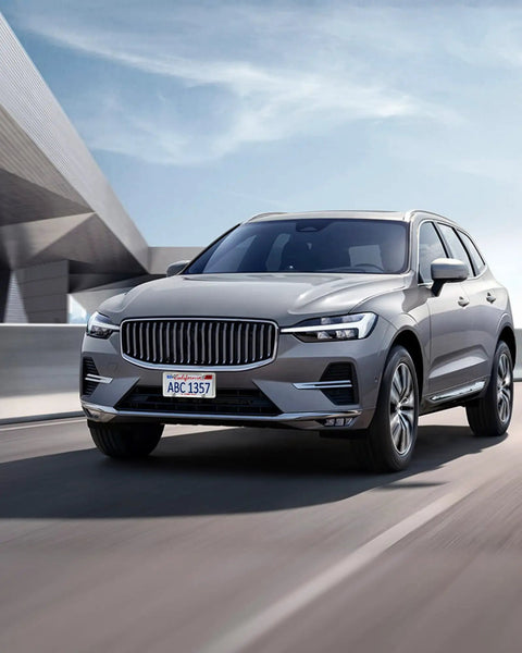 Volvo SUV on the road showcasing polished stainless steel license plate frame with slim edge, front view