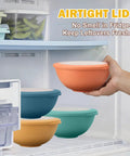 Hand holding Wheat Straw Bowls Set With Lids, 40 oz, eco-friendly dinnerware in a refrigerator with airtight lids