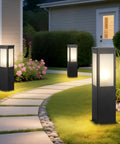 Modern Outdoor Bollard Pathway Lights Rock Solid Black Aluminum Yard Walkway Lamps With Waterproof White Glass hardwired, in garden at night.