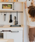 ABS Material Cabinet Locks 4 Pack For Cupboards And Drawers installed on kitchen cabinet with child nearby