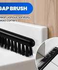 Close-up of gap brush from Extended-Handle Toilet Brush And Plunger 4-Piece Set with Cleaning Gloves, shown on tile edge.