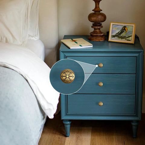Durable Zinc Alloy Vintage Cabinet Knobs Five Pack - Antique Brass Drawer Pulls Art Deco Star Detail 1 1/8 Inch on blue nightstand.