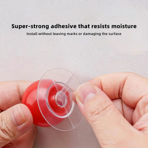 Person installing Eight Pack Self Adhesive Red Round Cabinet Knobs Peel And Stick Handles No Drill Needed with adhesive backing.