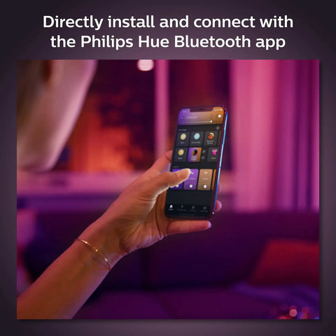 Person controlling Smart 4 Inch Recessed Downlight With Color Ambiance And White Finish 850 Lumen LED App Controlled using a smartphone app.