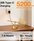 Wireless Boho Rattan Wall Sconce Set of Two, USB Type-C charging, 5200 mAh battery, sleek brass finish on a table.