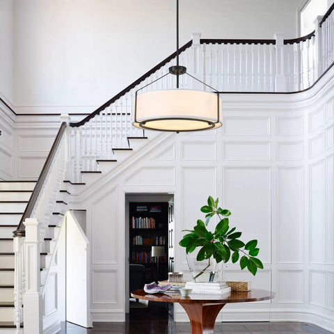 Grab This 20 Inch Drum Chandelier With 5 Lights For Instant Modern Farmhouse Vibes Featuring Soft White Linen Shades And Sleek Black Frames, hanging above a round wooden table.