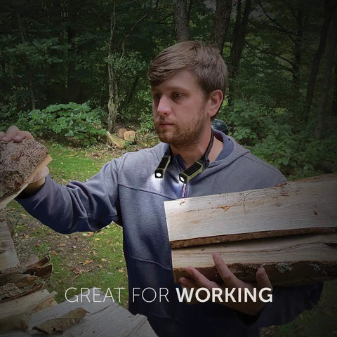 Man wearing hands free neck light for camping hunting and work, ultra bright with low mode, working with wood outdoors