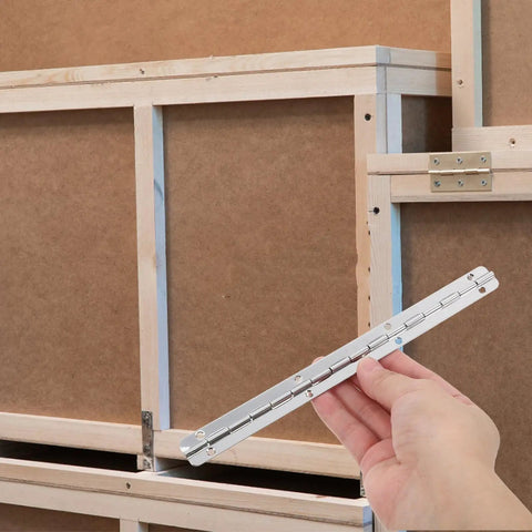 Hand holding 3 Pack Heavy Duty Piano Hinges For Cabinets And Wood Boxes Long And Short Butt Hinge Set in front of wooden frame
