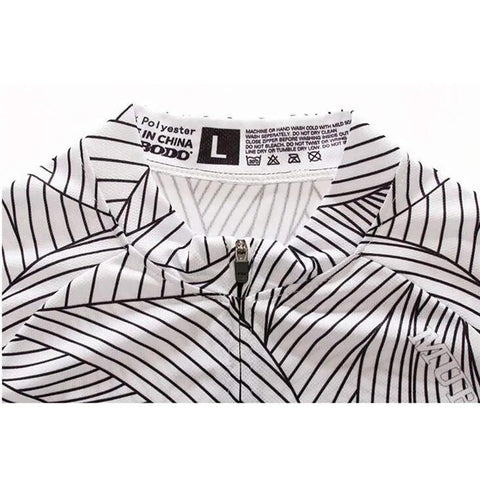 White and black patterned polyester garment with visible care label and size L tag