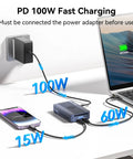 Twin Bay 40Gbps M.2 NVMe SSD Enclosure With Active Cooling And Machined Aluminum Case showing 100W fast charging setup on a desk.