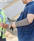 Top Rated Cut Resistant Wrist Sleeves And Breathable Forearm Guards Built Badass Tough For Mechanic Repair Gardening And Heavy Duty Welding Jobs Shield Your Arms Without That Sloppy Clunky Feel Dead Center Reliable Performance worn by a worker.