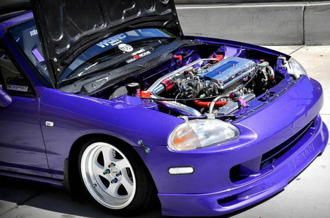 Front view of a purple car with hood open, featuring a visible engine; related to Universal Quick Release Fastener Kit With Neo Chrome Finish