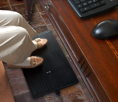 Person using Electric Foot Warmer Mat Portable Heated Rubber Floor Pad in office, 23x14 inch, 120 Watt, under desk